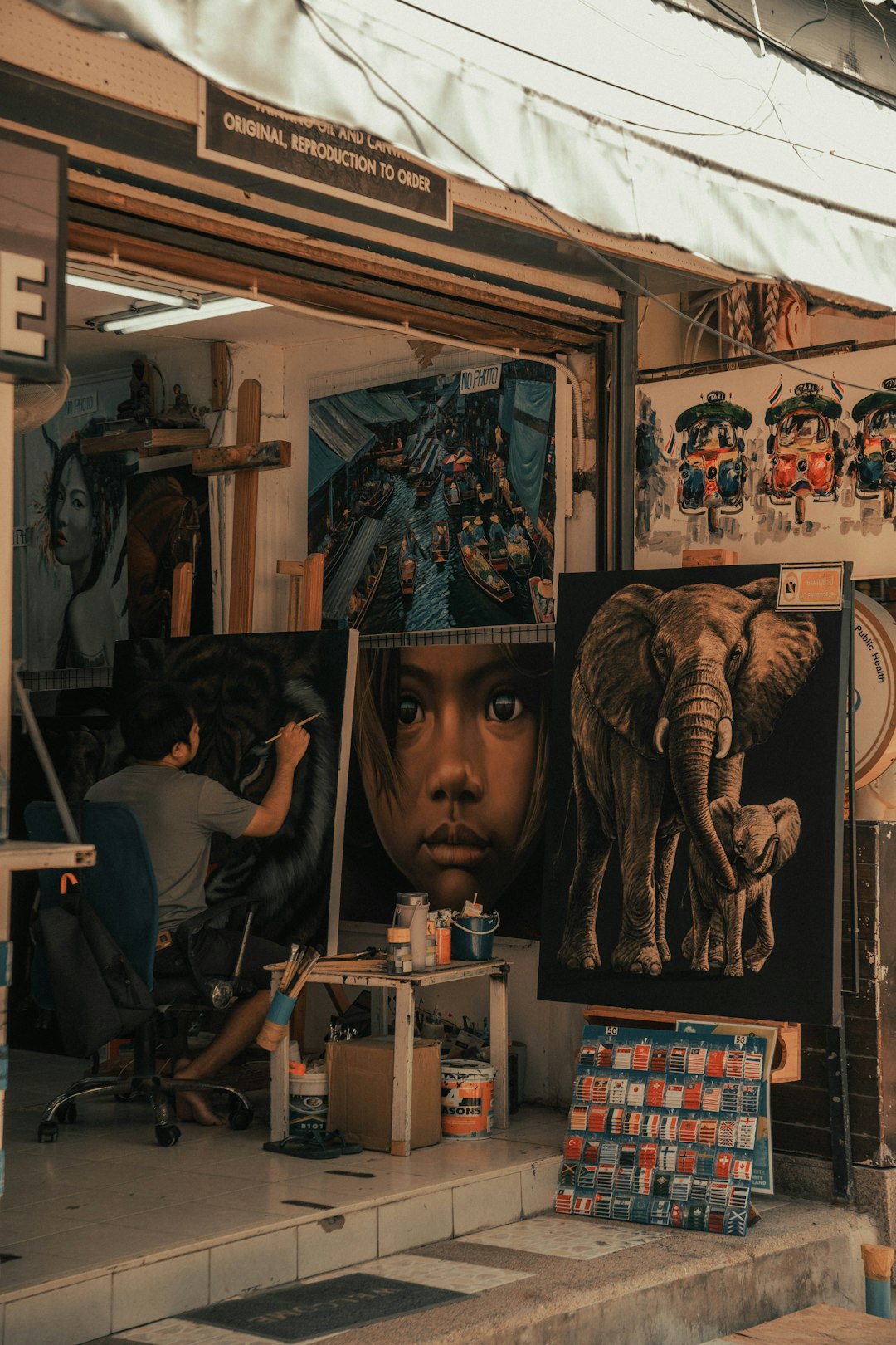 You are on a busy street in the Asian city, where culture and creativity come together. You are drawn to a street artist who paints on a small easel, using colors that capture the beauty of nature